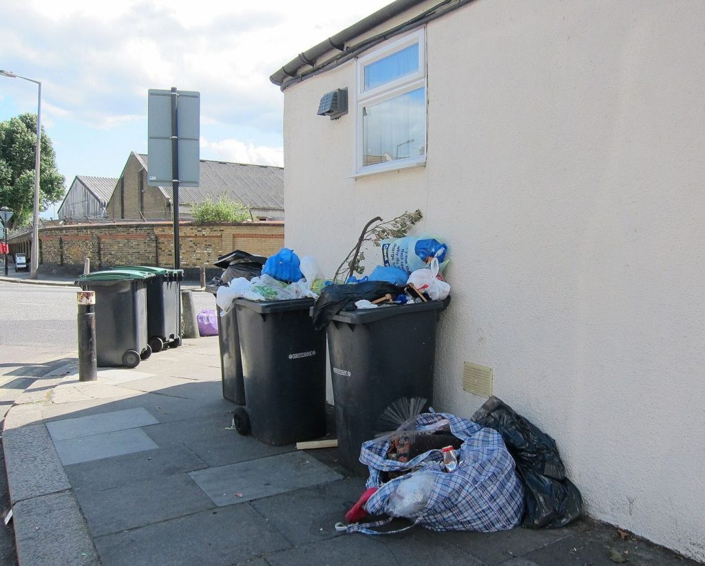 colourful recycling bins outside homes