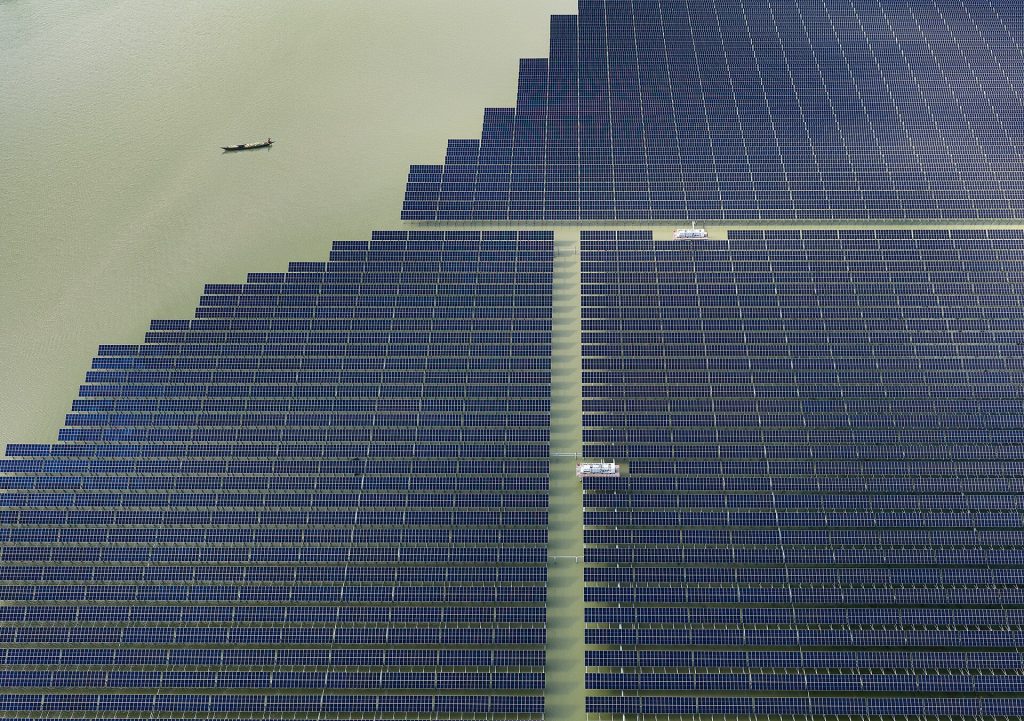 Solar panels in sunlight, illustrating the durability challenge facing new perovskite photovoltaic technology.