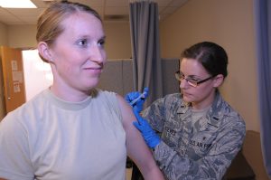 A healthcare worker preparing a measles vaccination dose at a clinic